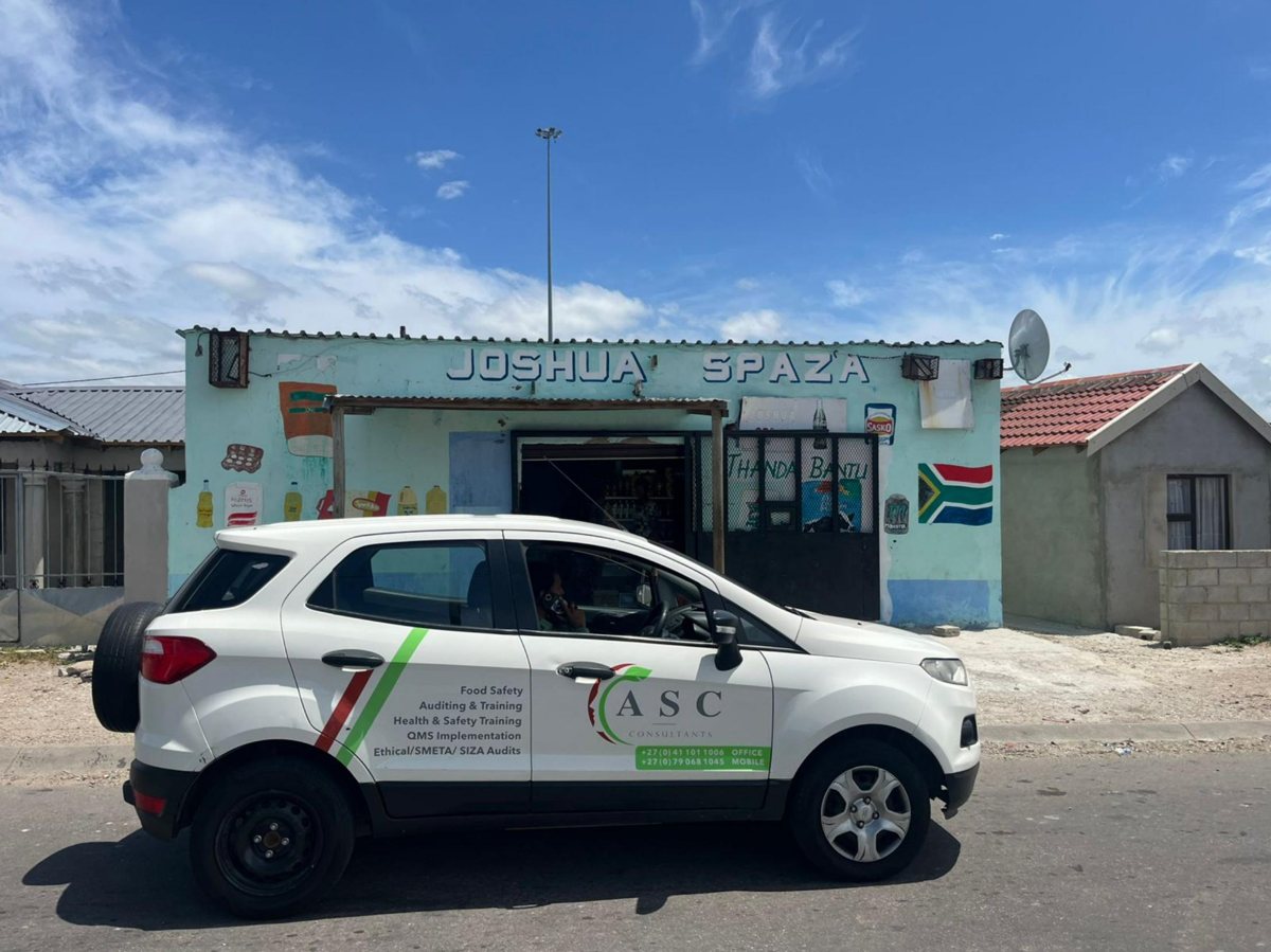 A branded ASC Pest Control vehicle on site at a township spaza shop